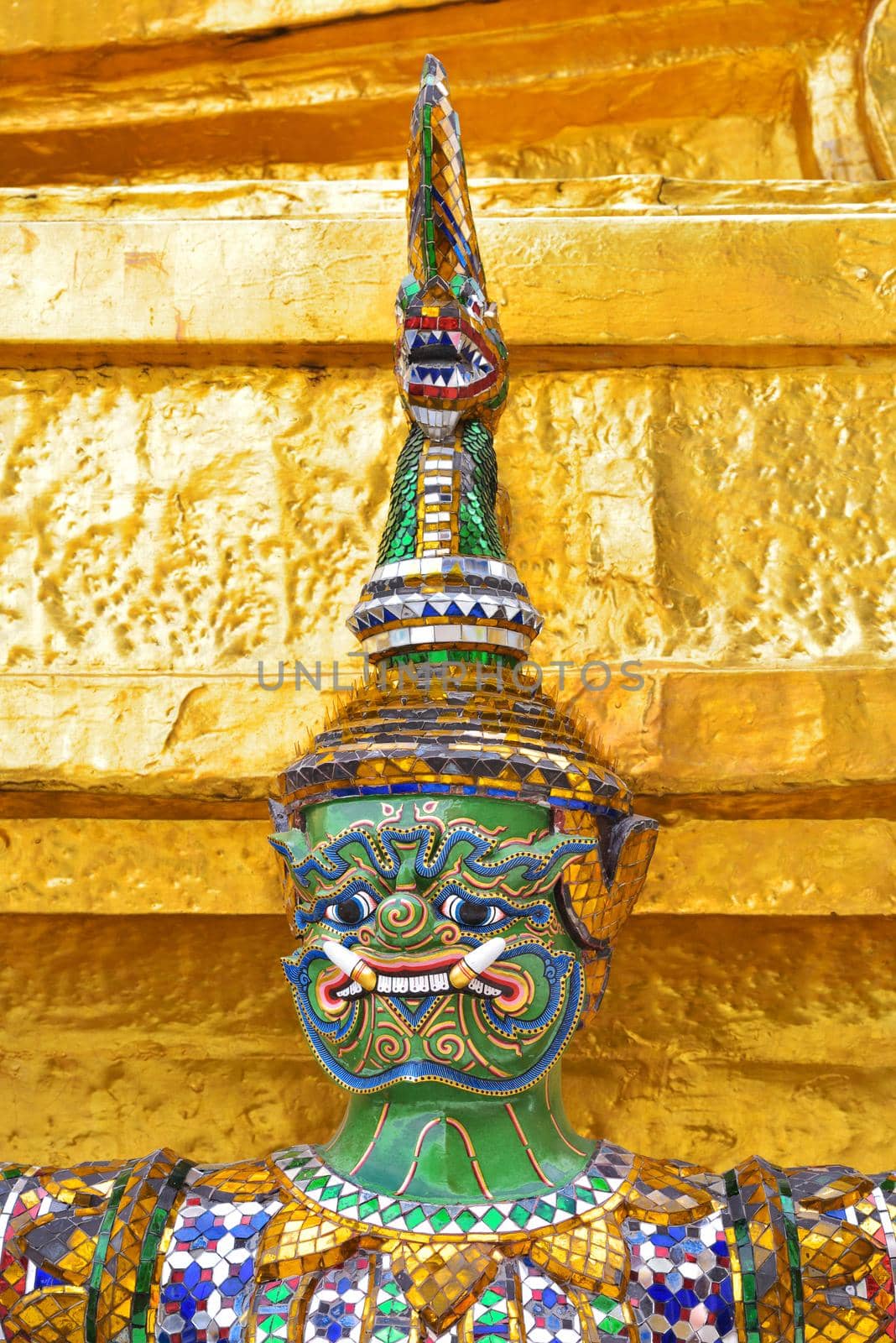 closeup face and headdress of Yak(giant) statue at Wat Phra Kaew in Bangkok, Thailand.