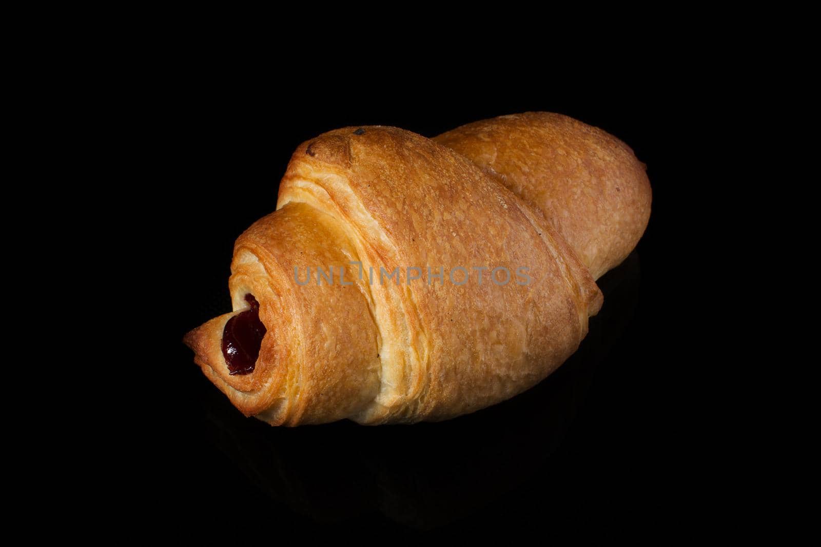 Puff pastry with jam on a dark background