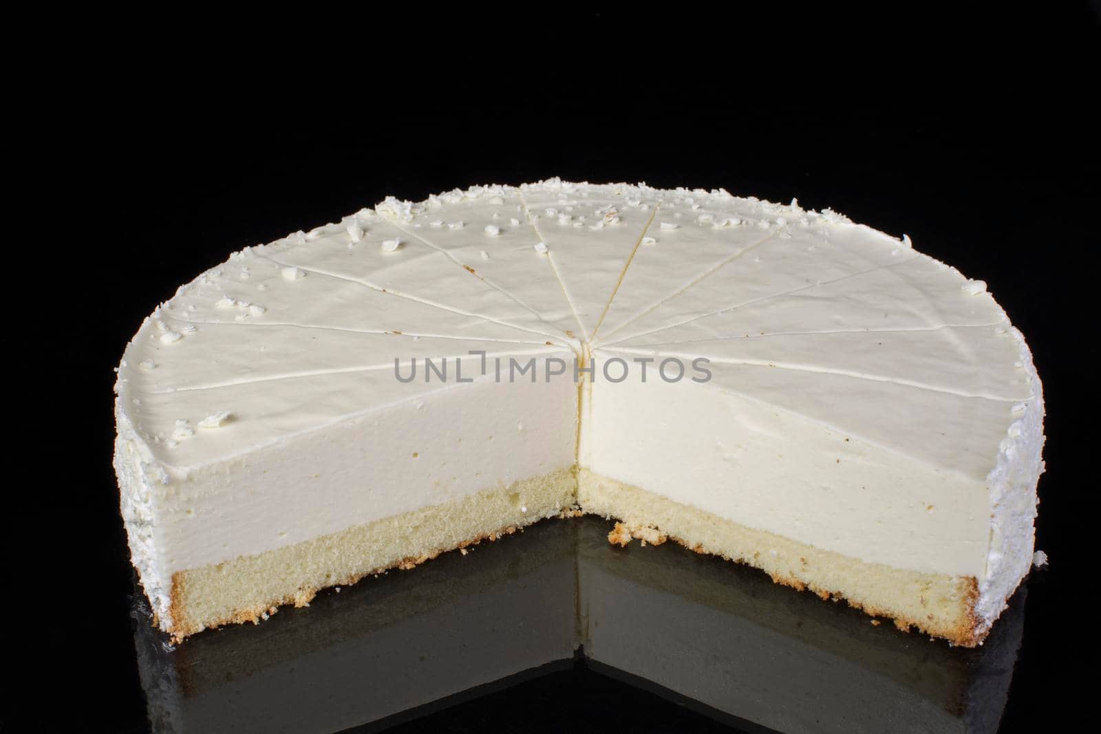 Cake cheesecake sliced in portions on a black background