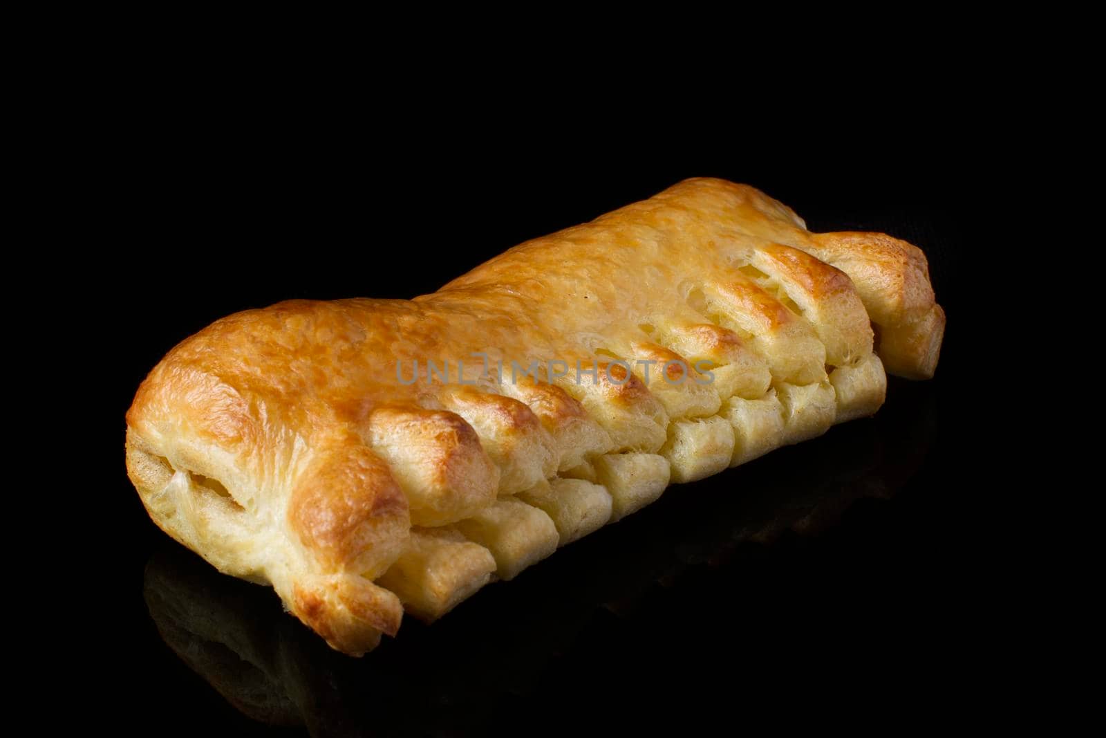 Bun with a puff pastry on a dark background