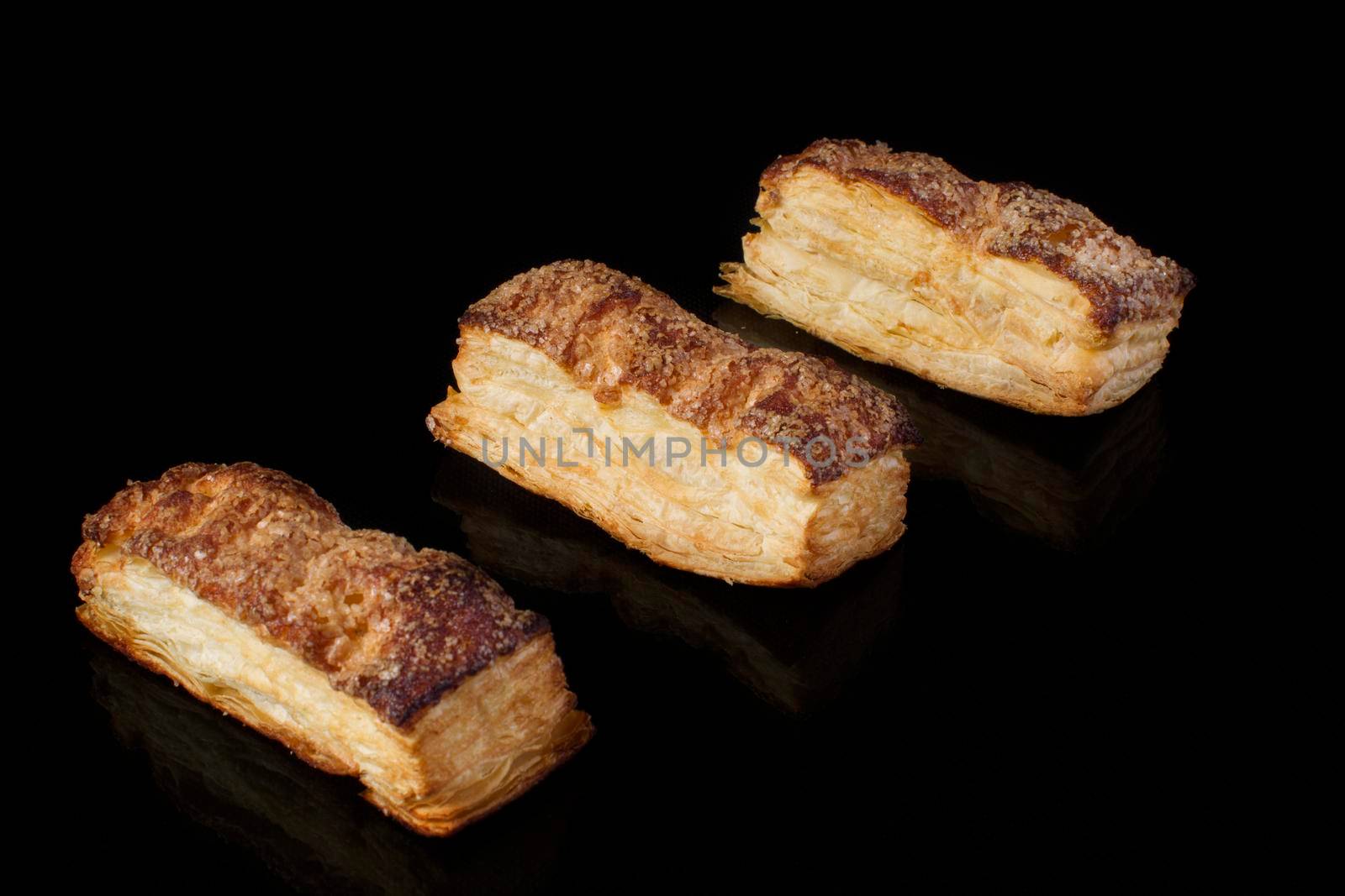 Puff pastry cookies on a black background