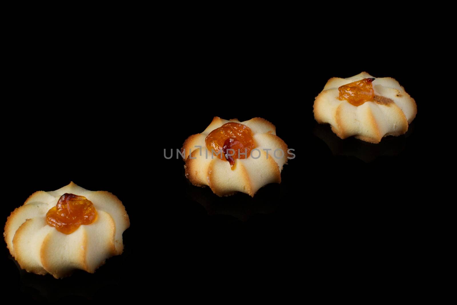 Shortbread cookie with jam on a dark background