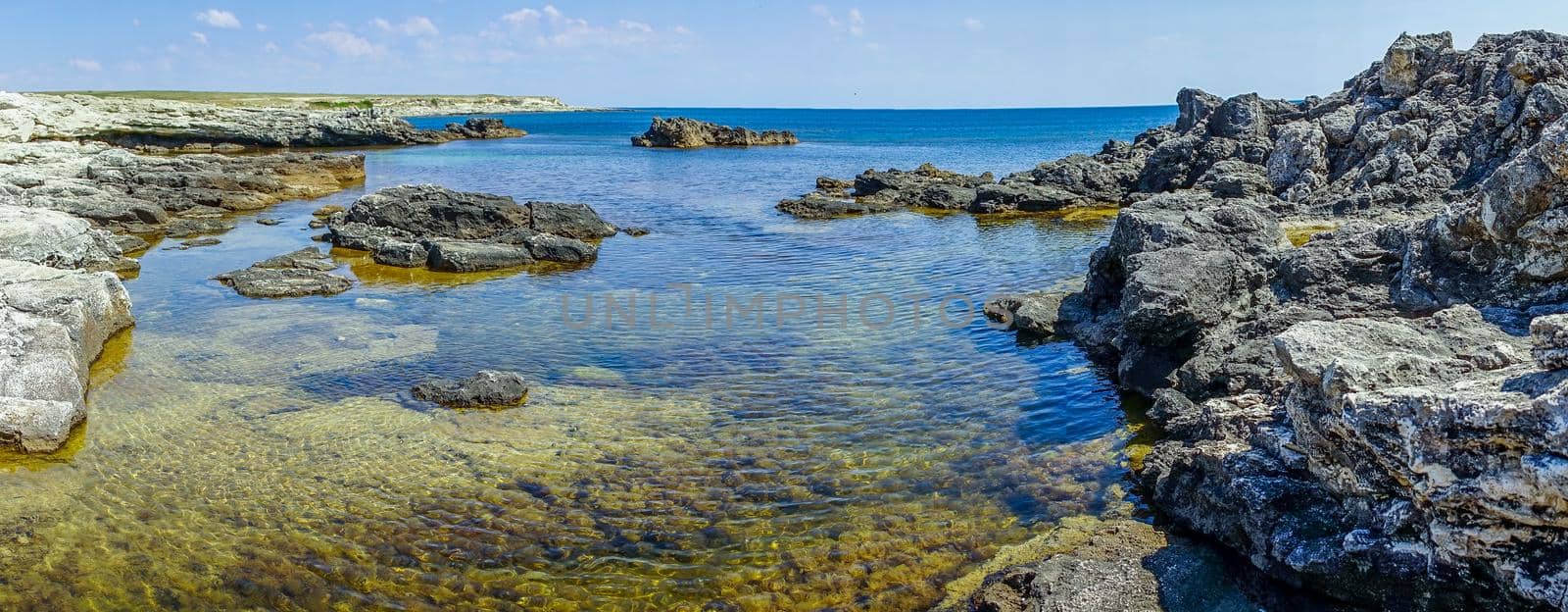 The steep and steep coast of Cape Tarkhankut and the deep Black sea in Crimea. Sunny day
