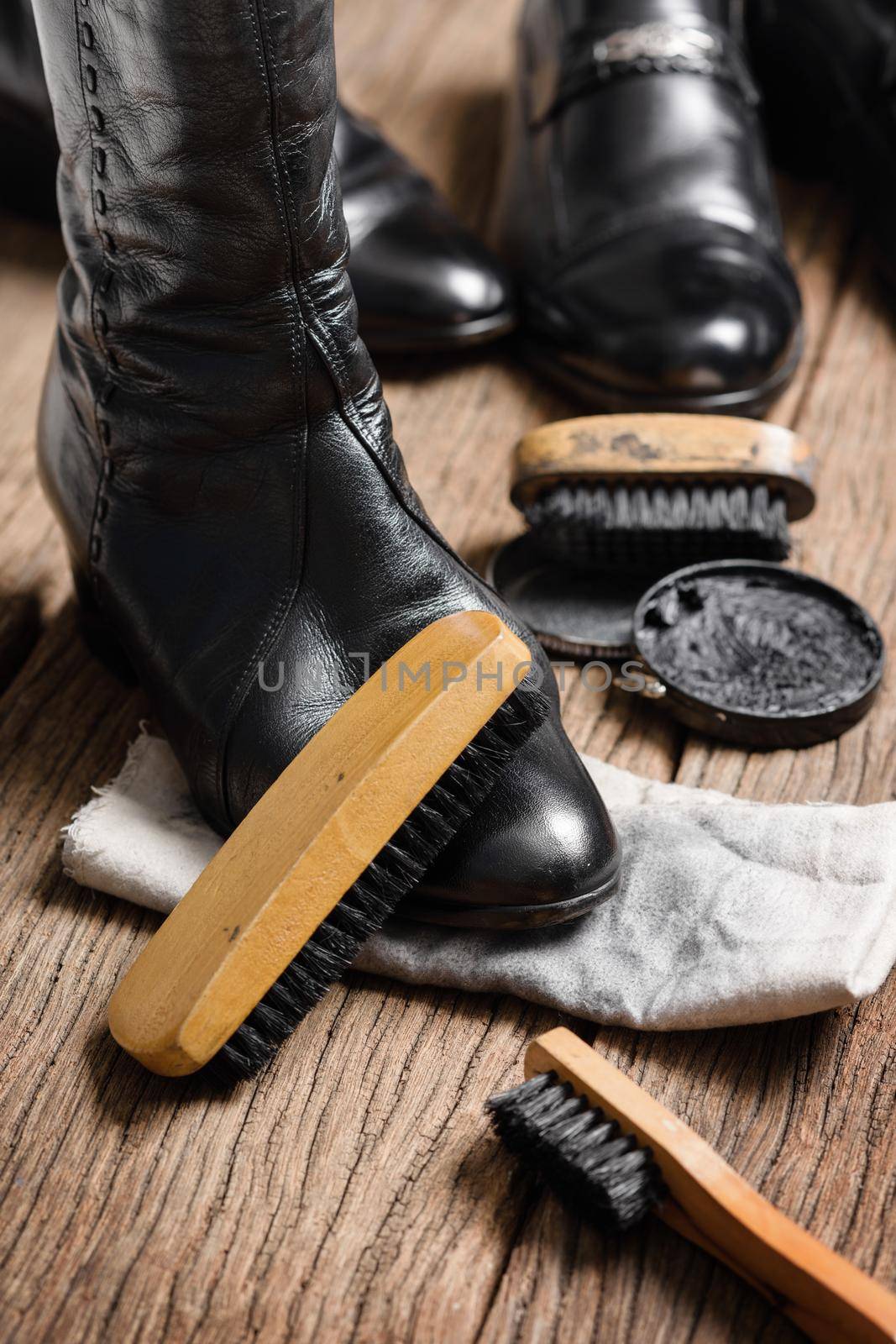 black leather boots with shoe maintenance set