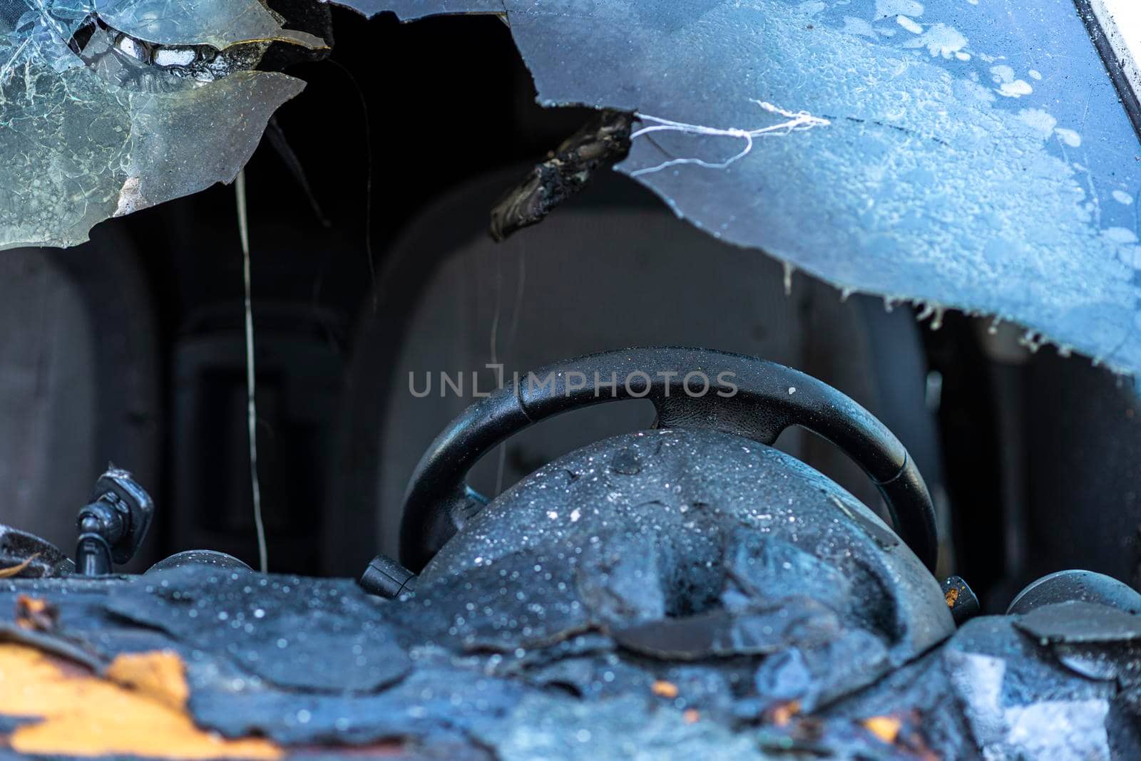 Burned car close up. Car after the fire, crime of vandalism, riots. Arson car. Accident on the road due to speeding. Explosion. High quality photo