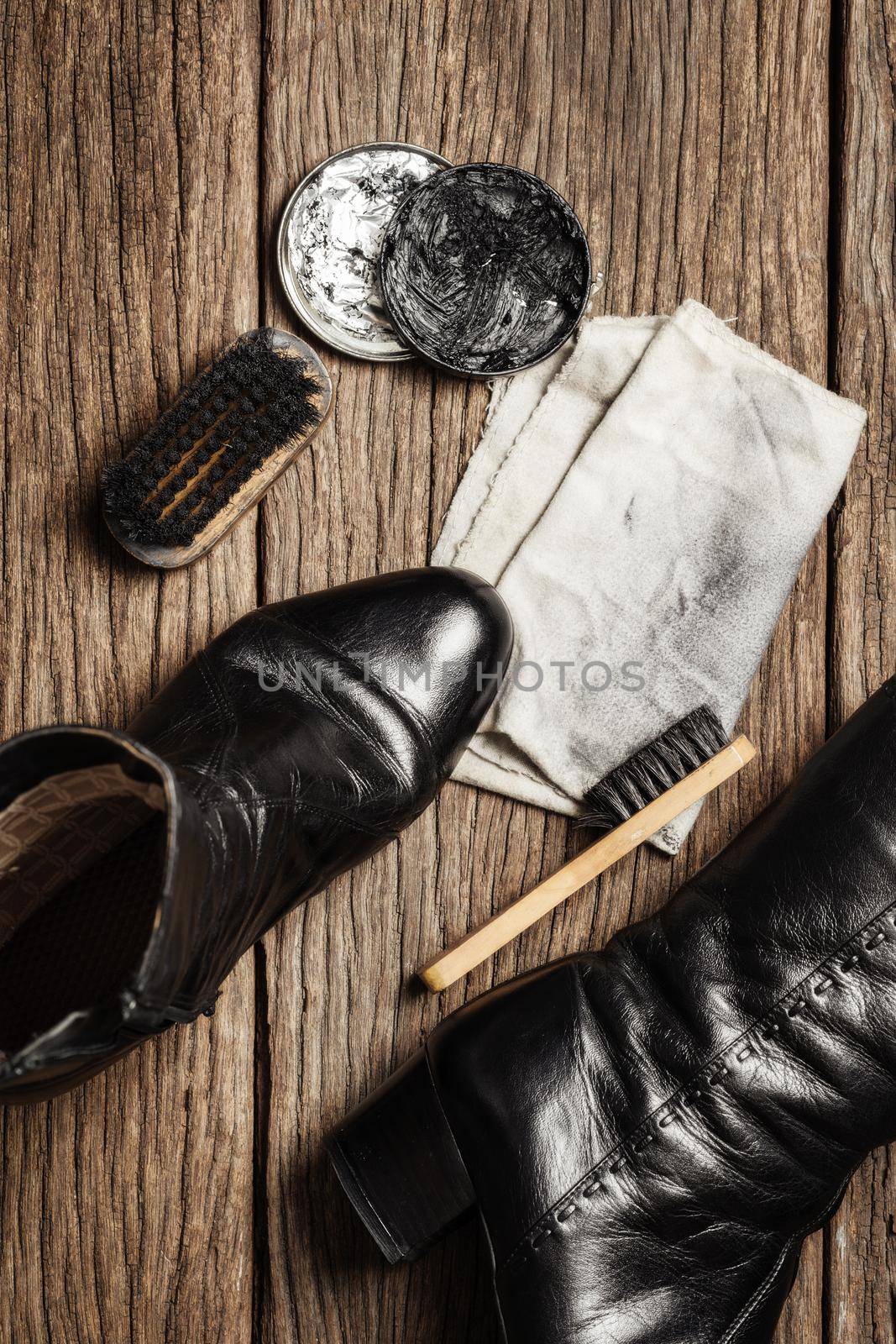 black leather boots with shoe maintenance set