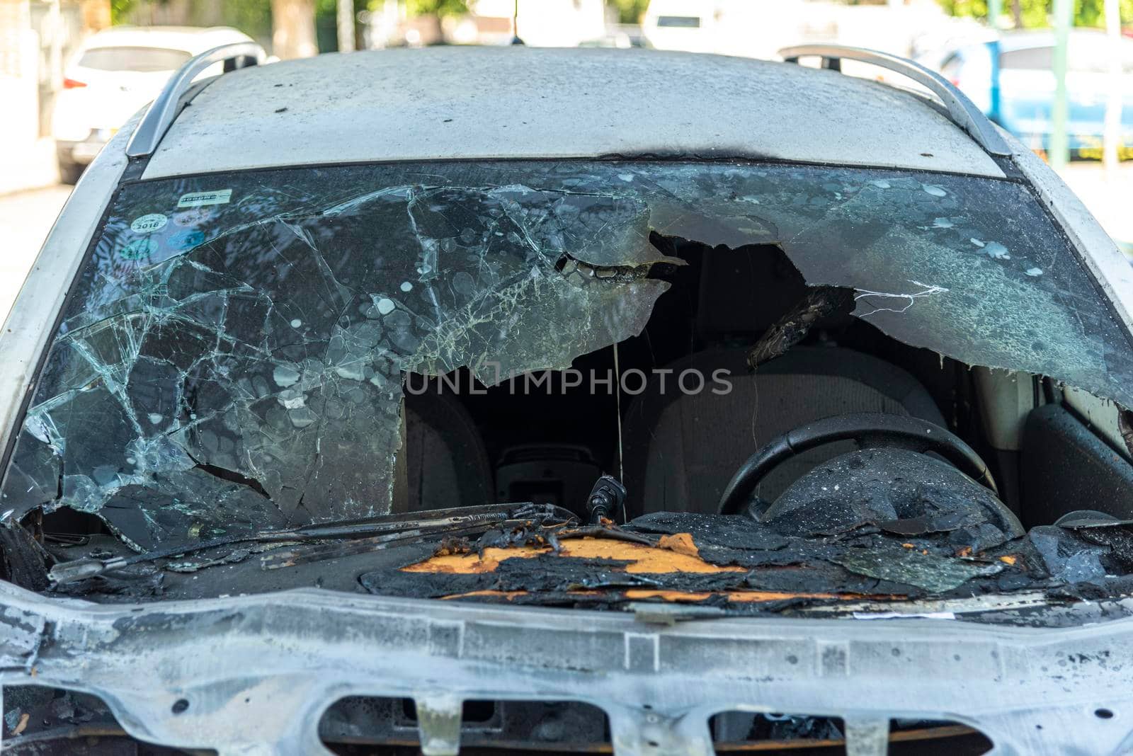 Burned car close up. Car after the fire, crime of vandalism, riots. Arson car. Accident on the road due to speeding. Explosion. High quality photo