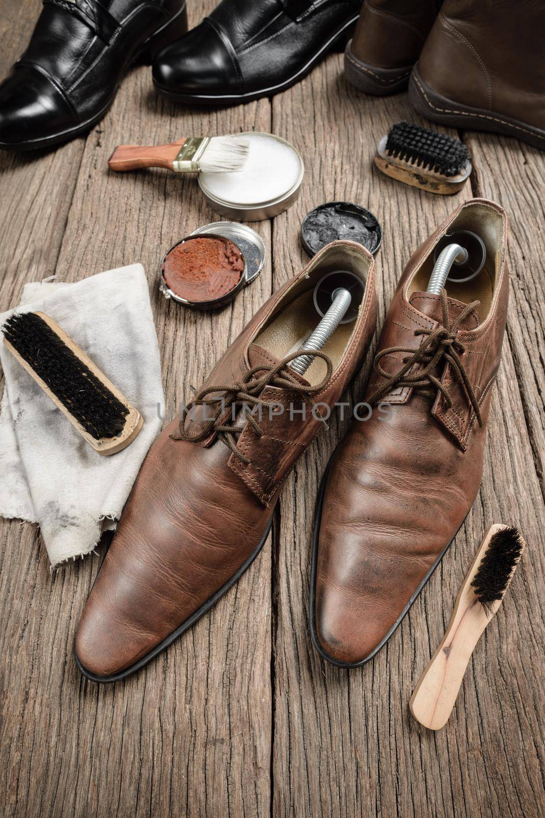 brown leather boots with shoe maintenance set