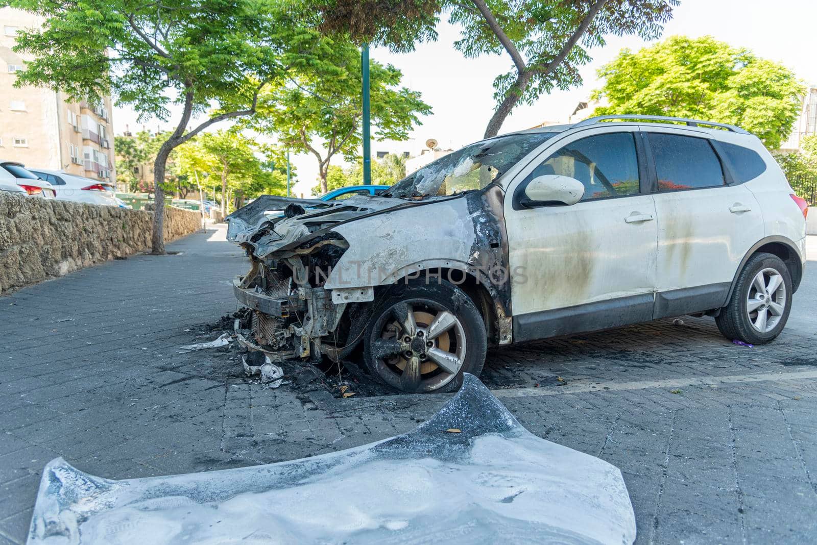 Burned car close up. Car after the fire, crime of vandalism, riots. Arson car. Accident on the road due to speeding. Explosion. High quality photo