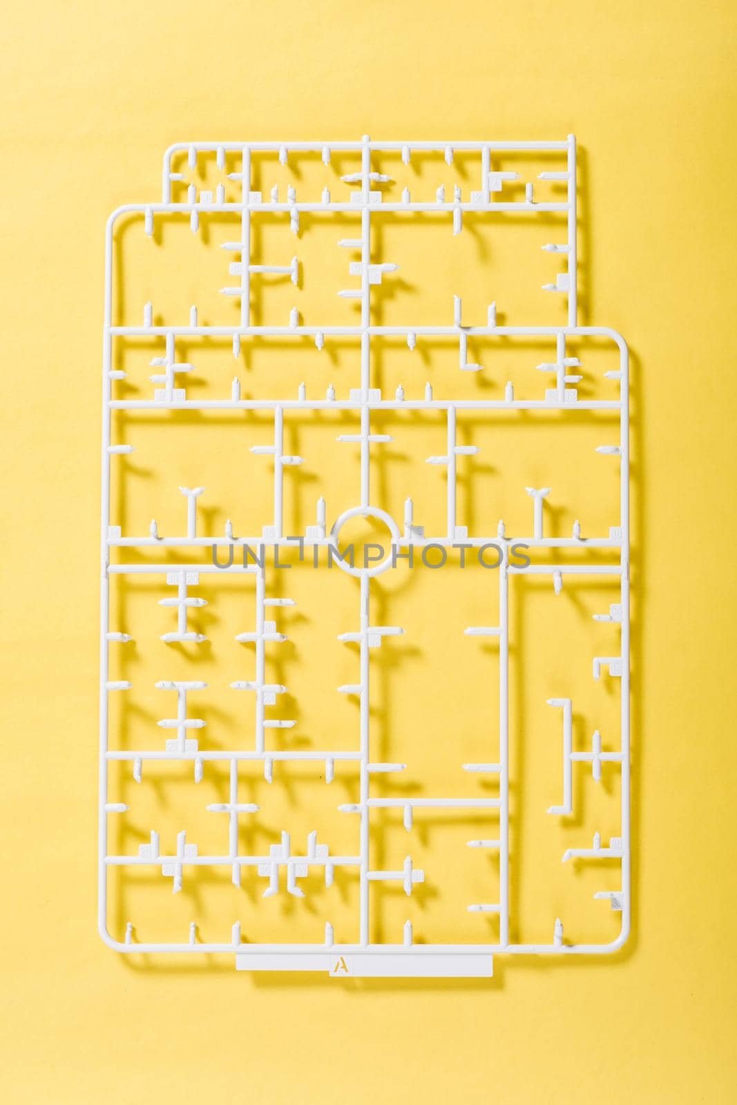 sprue or injection moulding of model on yellow background