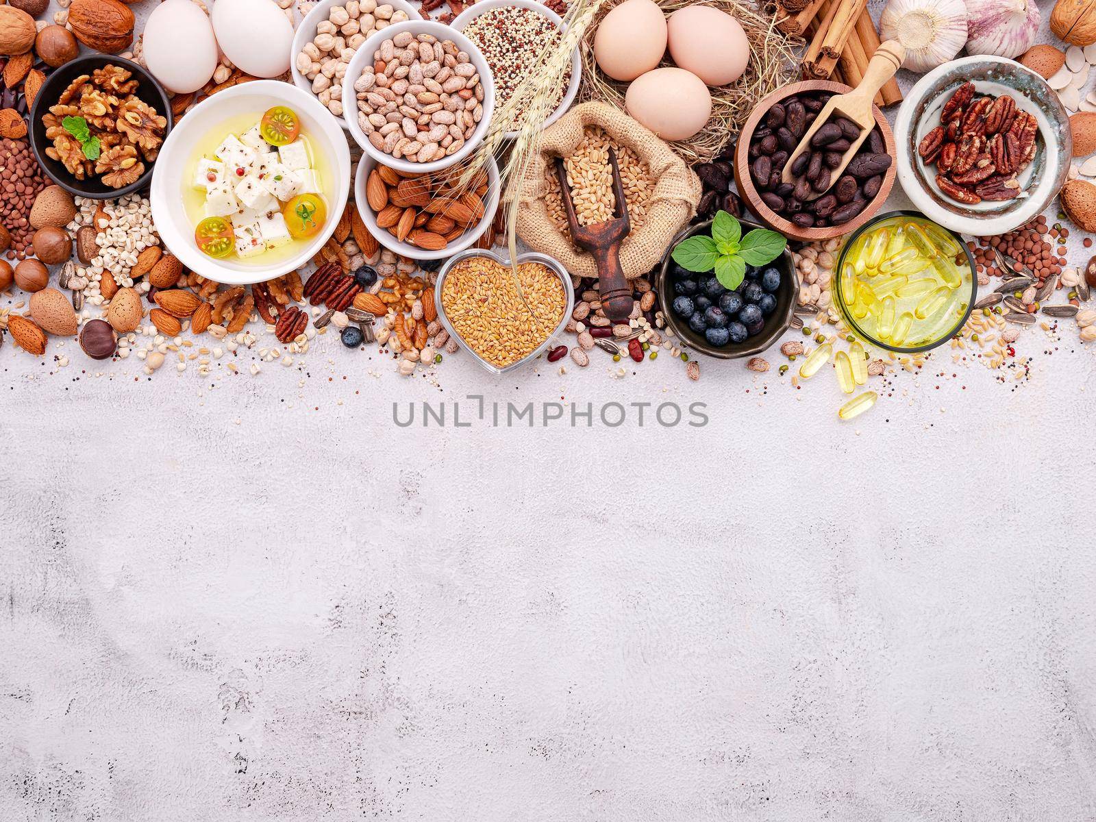 Ingredients for the healthy foods selection. The concept of superfoods set up on white shabby concrete background with copy space. by kerdkanno