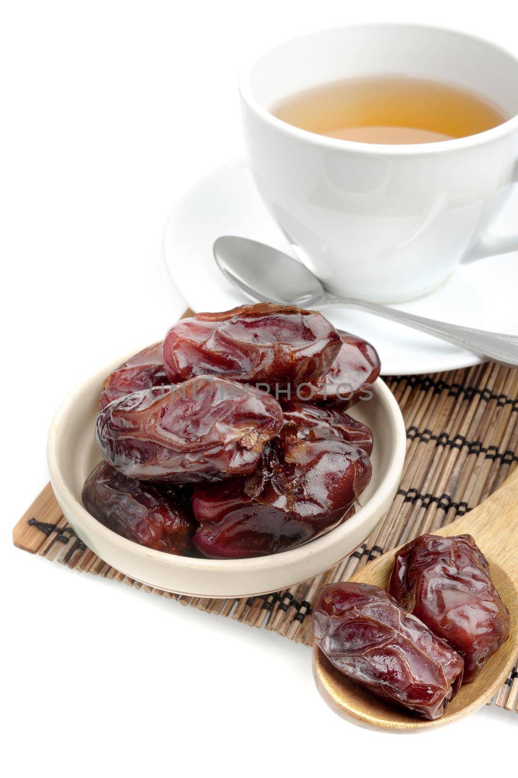 closeup sweet dried dates fruit with tea