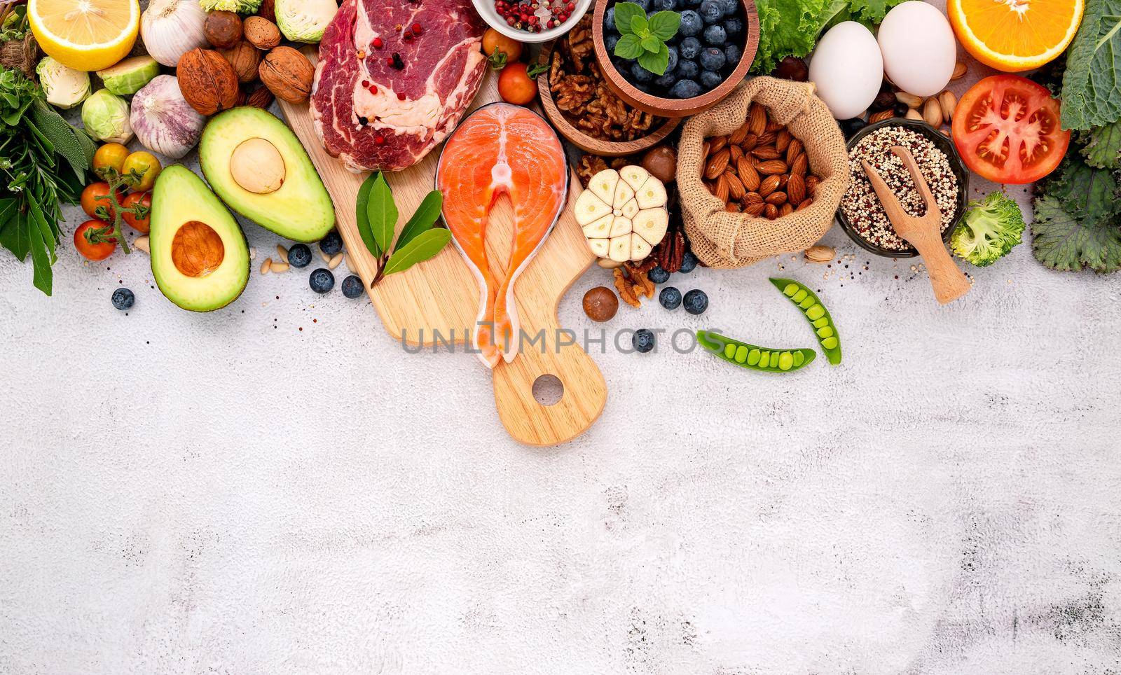 Ketogenic low carbs diet concept. Ingredients for healthy foods selection set up on white concrete background.  by kerdkanno