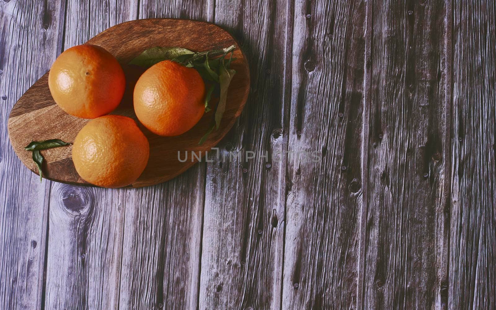 Oranges on wooden floor by raul_ruiz