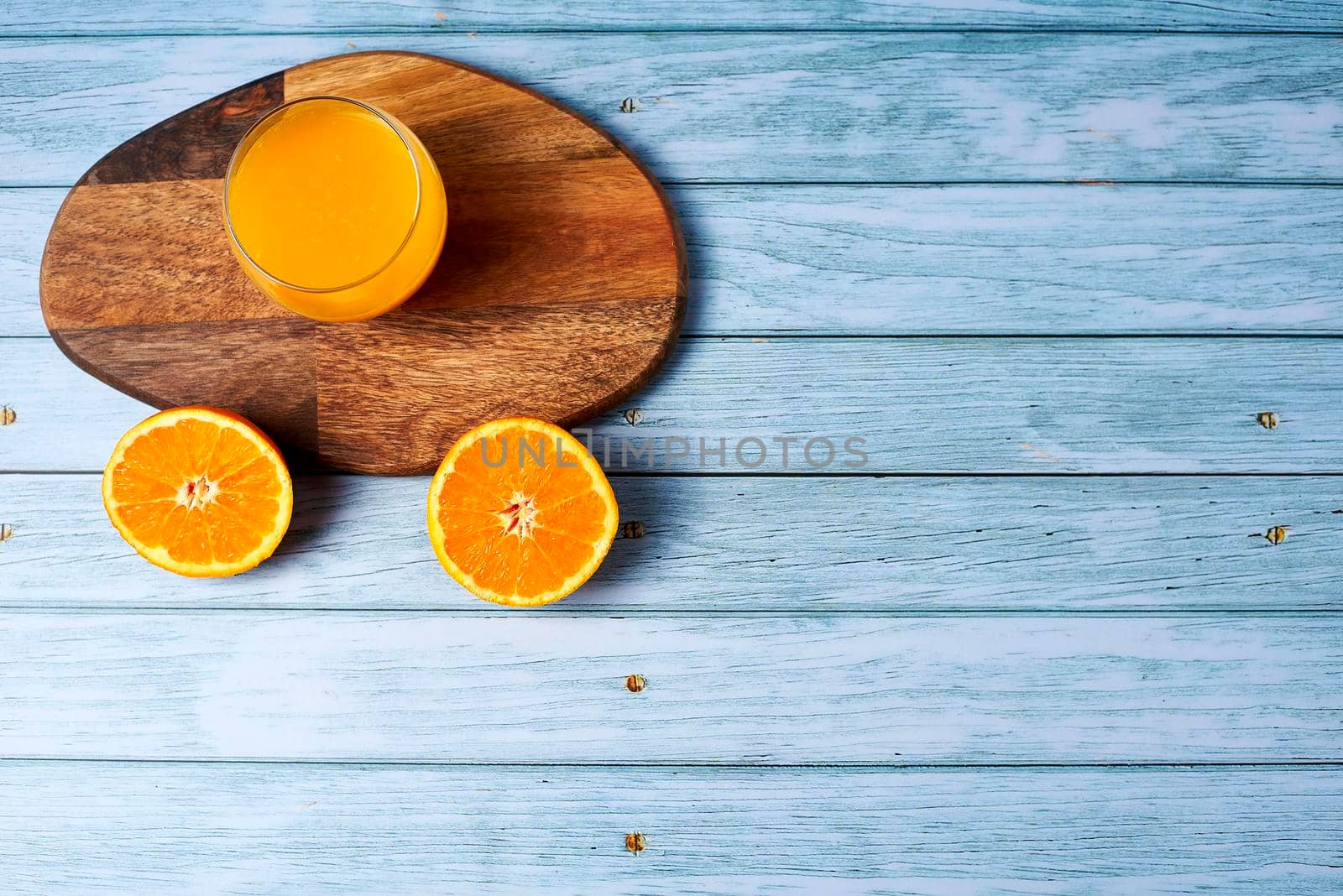 Glass of orange juice with cut oranges by raul_ruiz