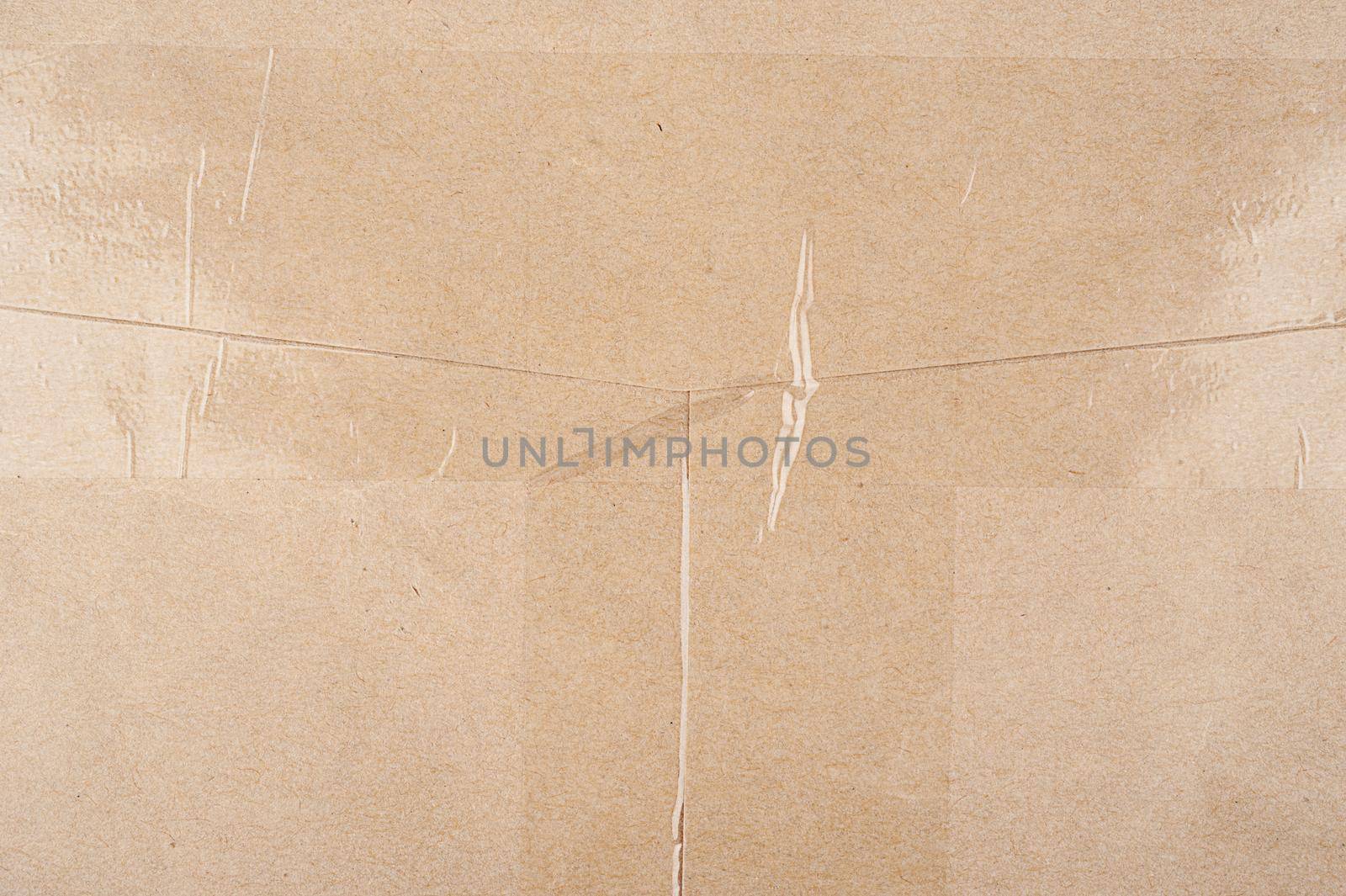 abstract texture of light brown recycled paper with plastic tape