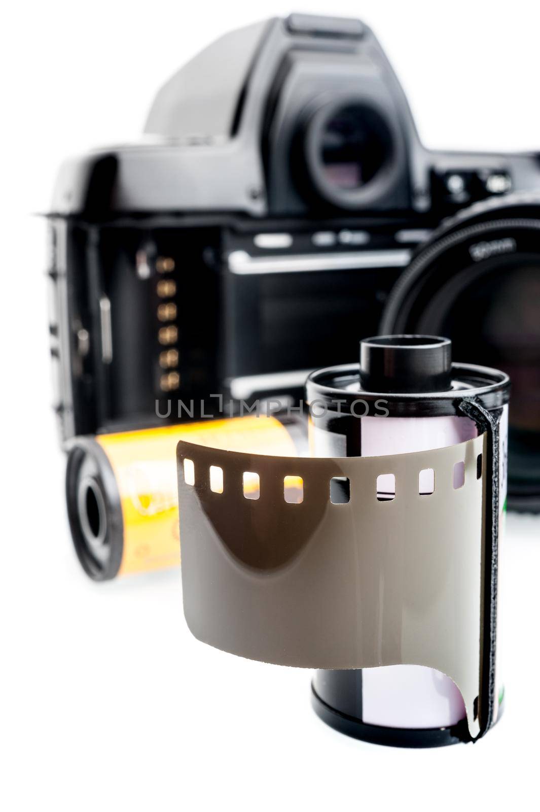 closeup camera film and black camera with opened back lid on white background