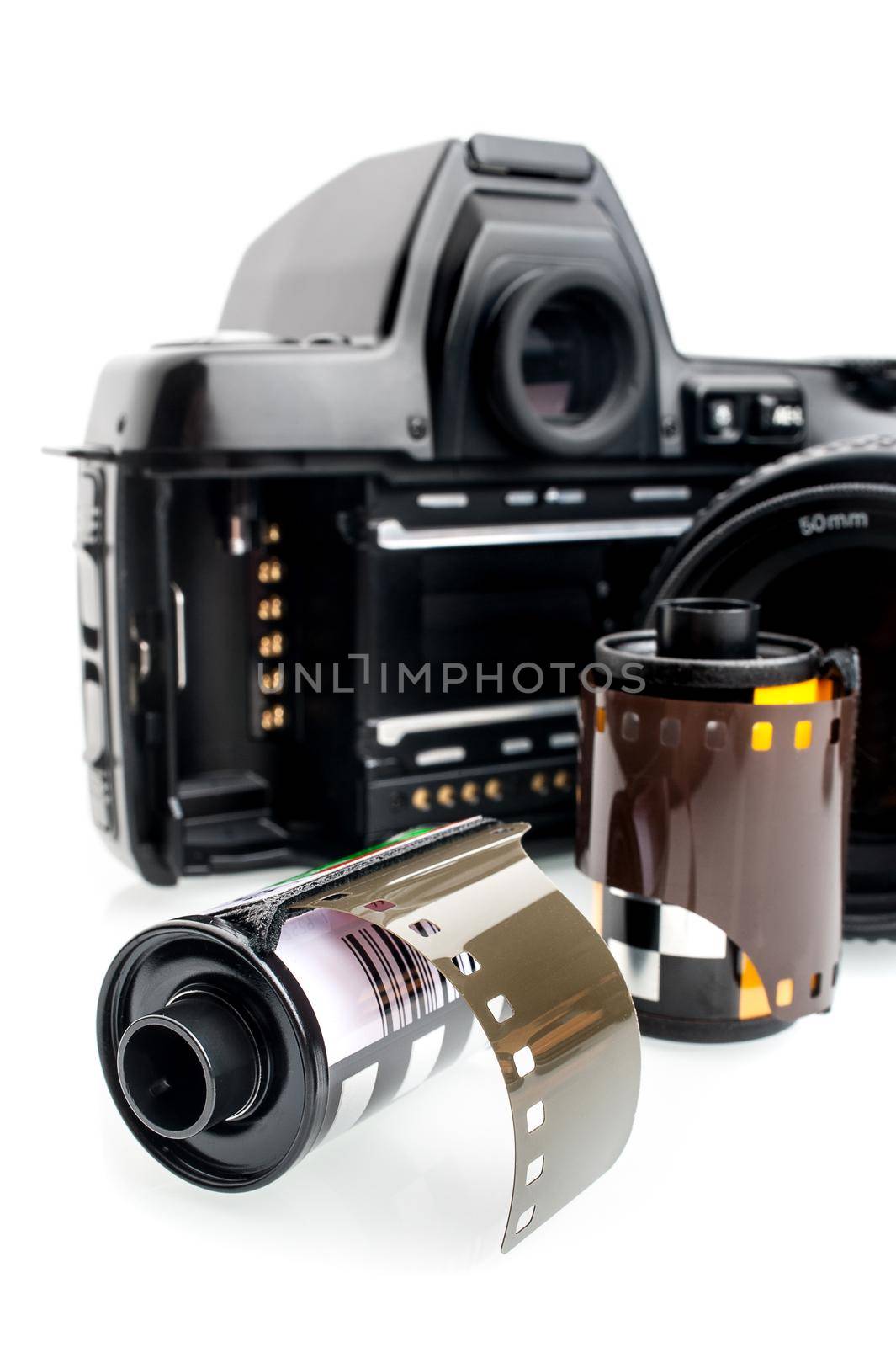 closeup camera film and black camera with opened back lid on white background