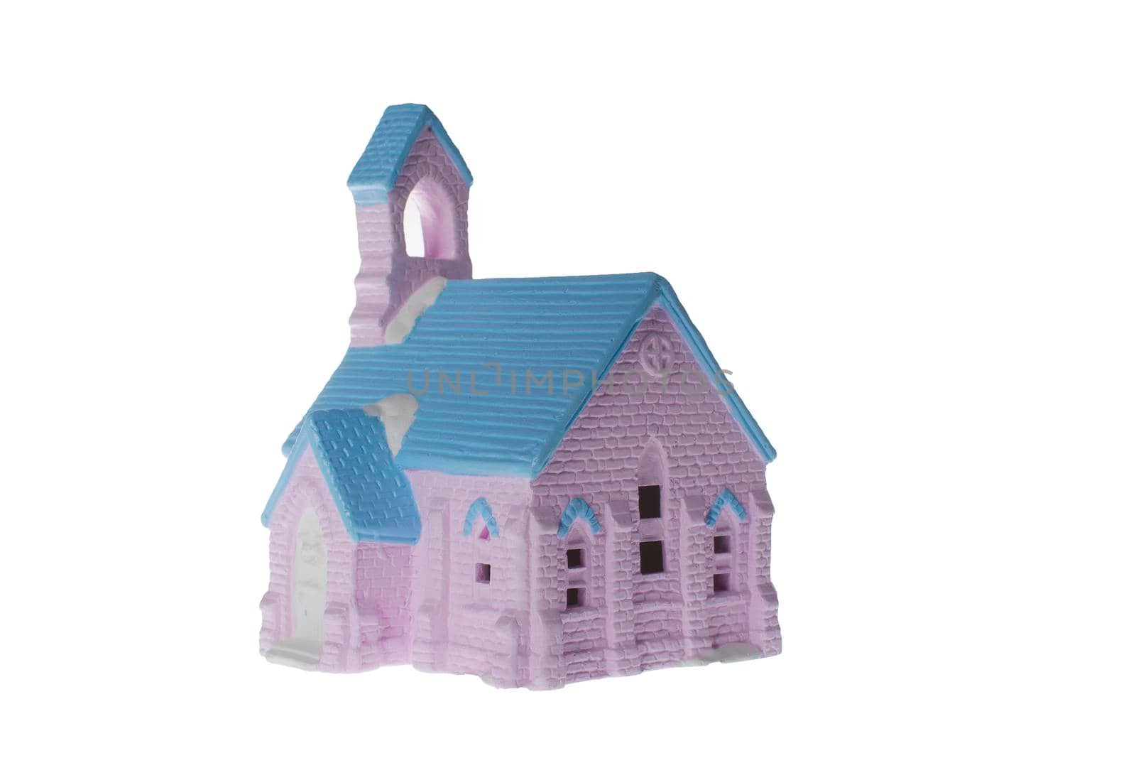 Children's small house on a white background.A gypsum product painted with acrylic paint in the form of a village house