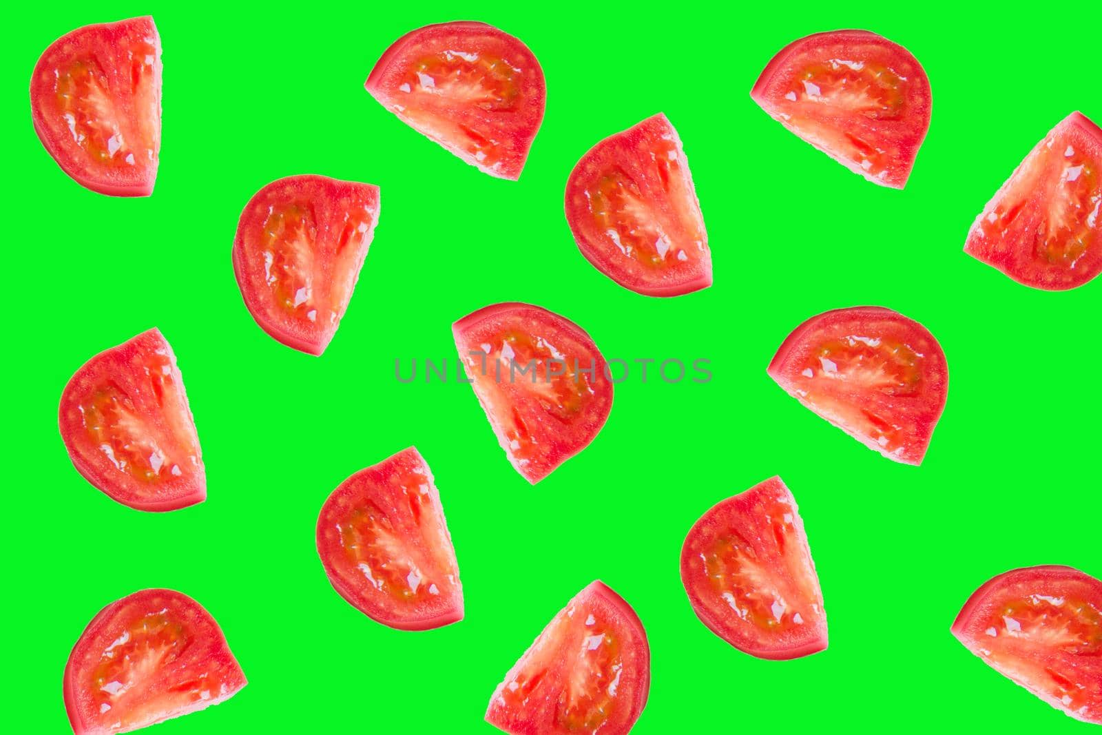 Slice the tomato on a bright green background