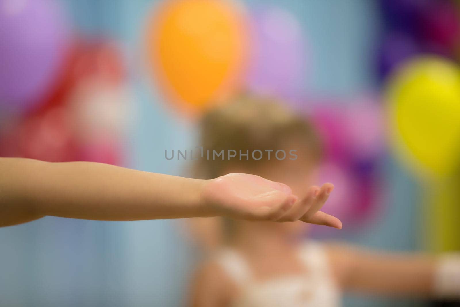 Outstretched hand on a bright blurred background