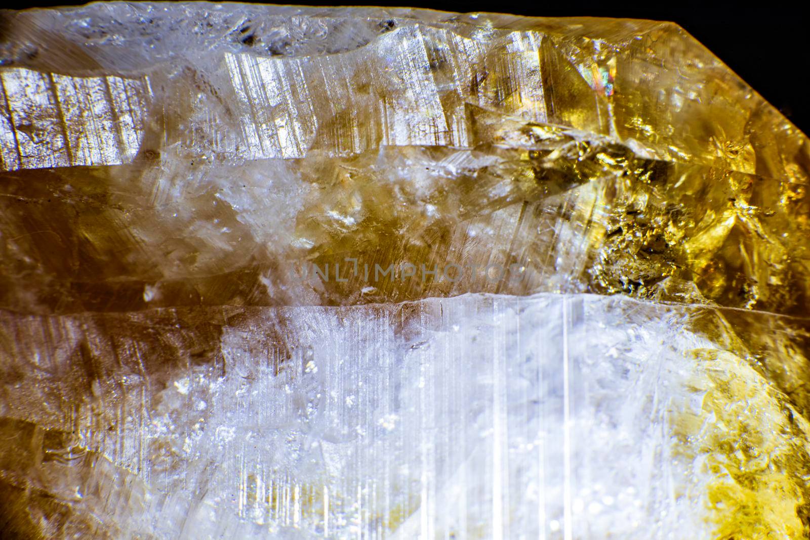 macro shooting of natural rock specimen. Raw crystal of Citrine yellow quartz gemstone from Brazil. Shimmering gold background. High quality photo