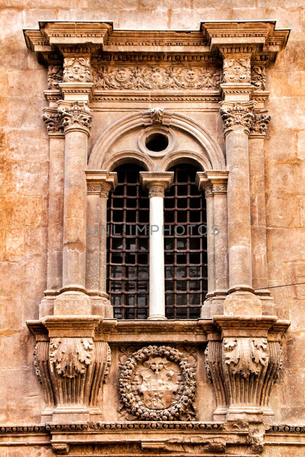 Window and carved stone details of the main facade of the Cathedral of Murcia.