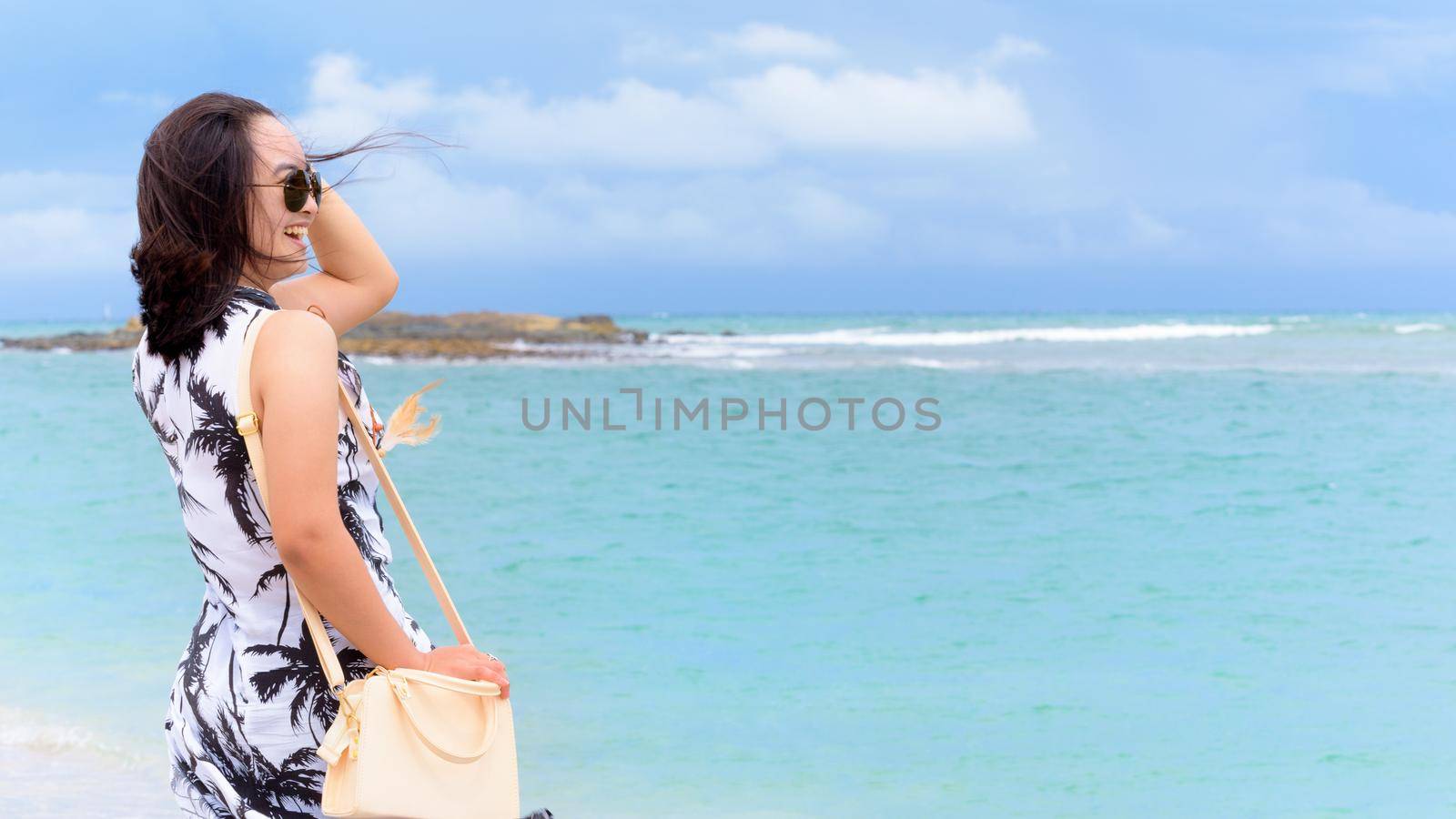 Beautiful nature landscape the beach and sea in summer sky and cheerful woman tourist wearing sunglasse laughing with happy on Tarutao island, Satun, Thailand, 16:9