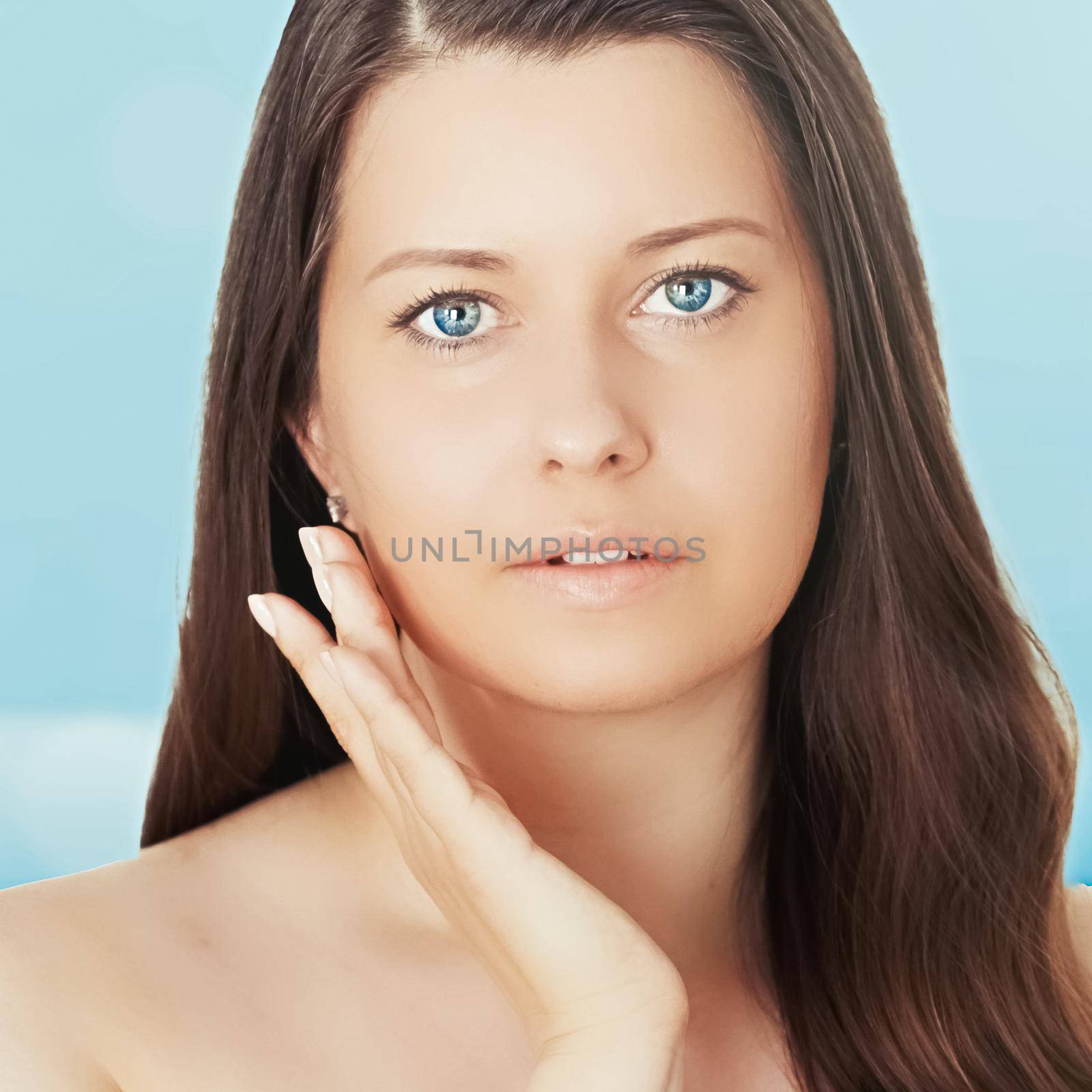 Skincare and sun protection in summer. Portrait of a beautiful young suntanned woman, blue sea and sky on background, beauty, wellness and travel concept.