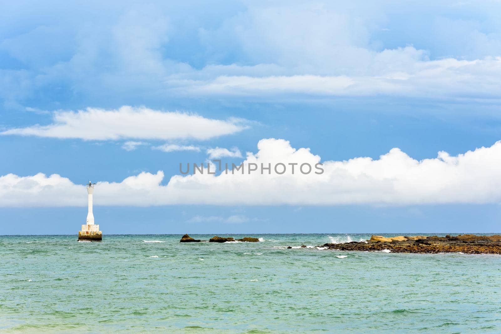 Beautiful nature landscape of the sea, rock and lighthouse near the coast on blue sky summer background at Koh Tarutao island National Park, Satun province, Thailand