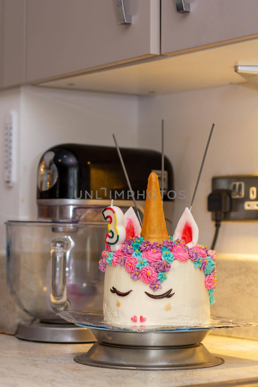 Close-up of a unicorn decorated birthday cake on a kitchen counter