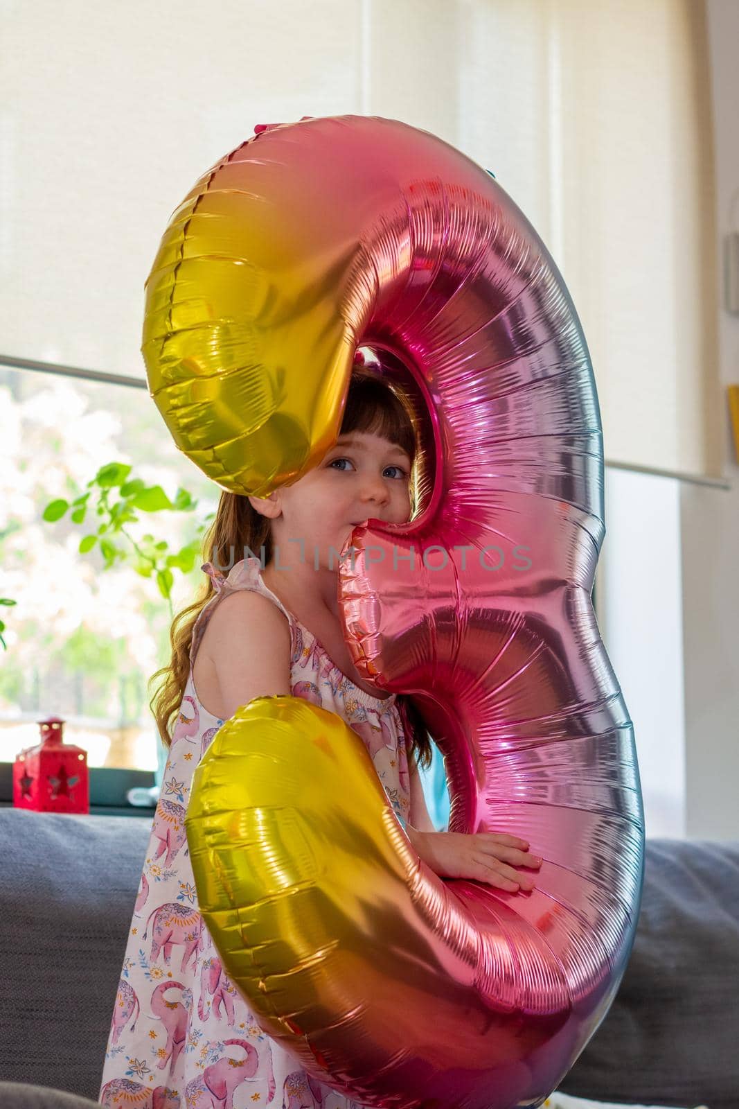 A Cute Baby Girl Holding A Number Three Balloon by AlbertoPascual
