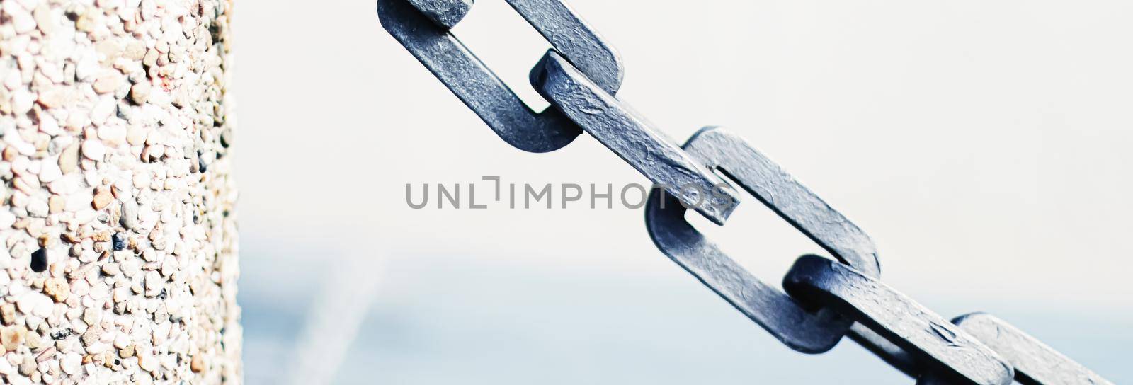 Metal chain closeup, marine background.