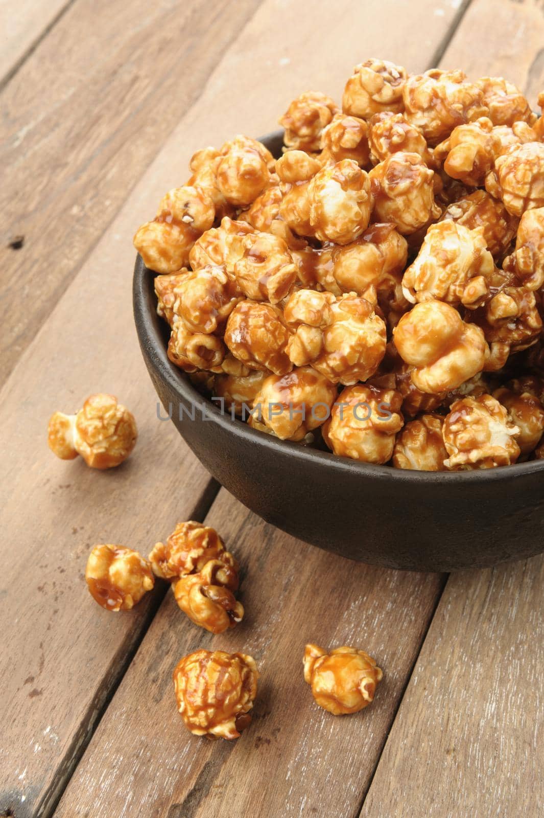 caramel popcorn isolated on wooden desk