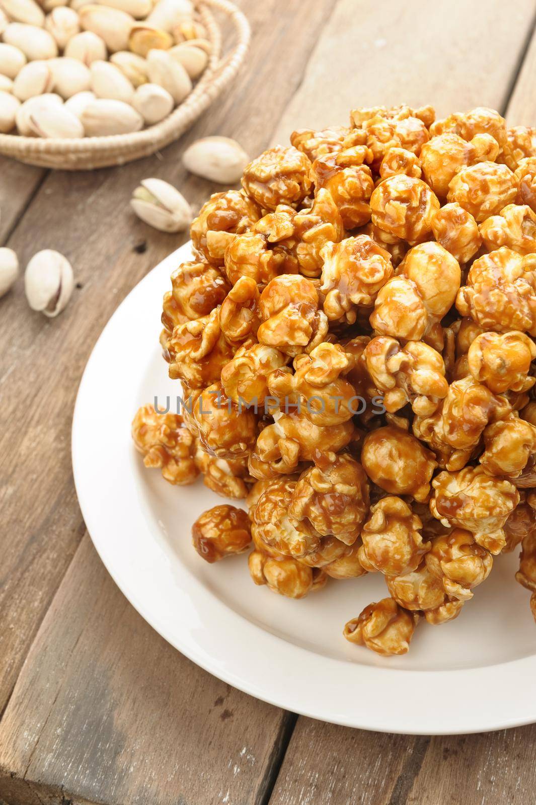 caramel popcorn isolated on wooden desk