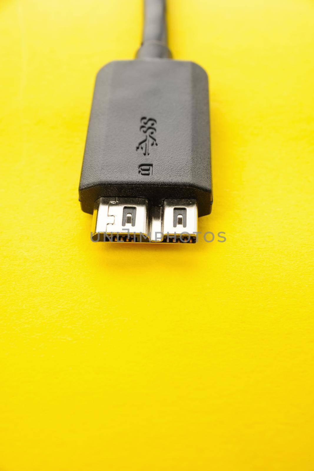 closeup detail of USB 3.0 connector on yellow paper