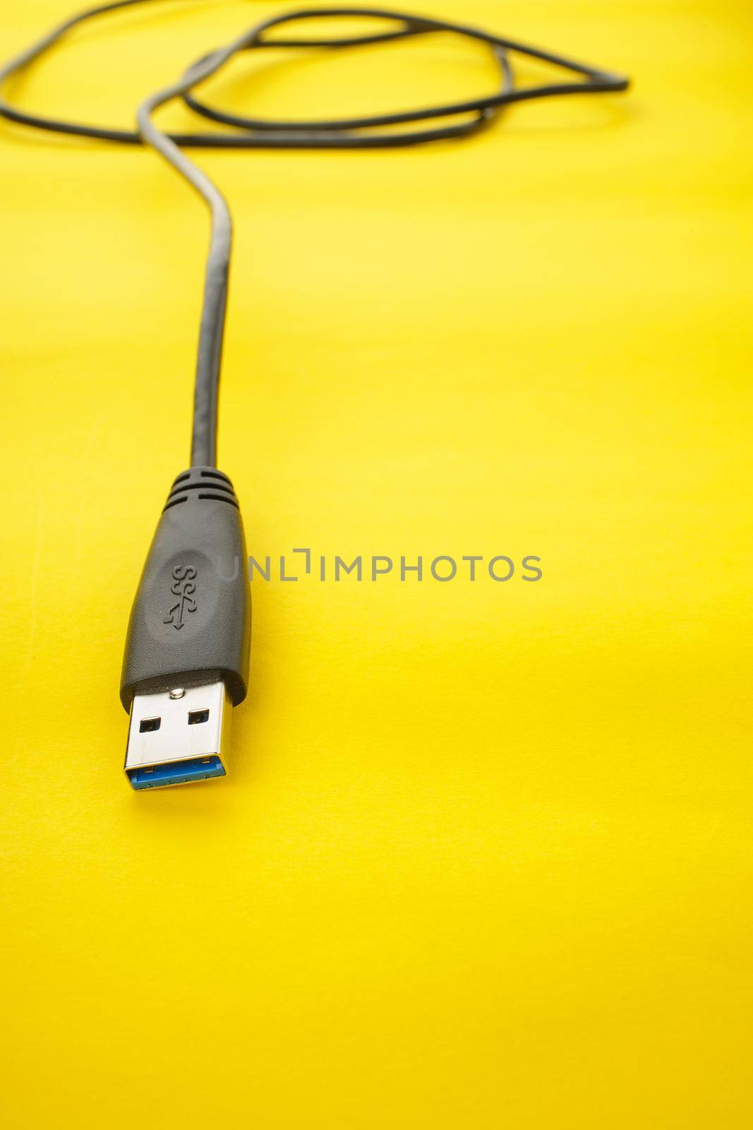 closeup detail of USB 3.0 connector on yellow paper