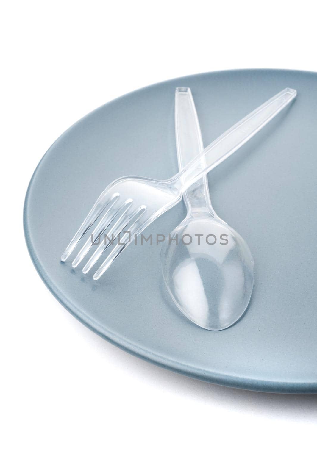 closeup plastic cutlery on plate