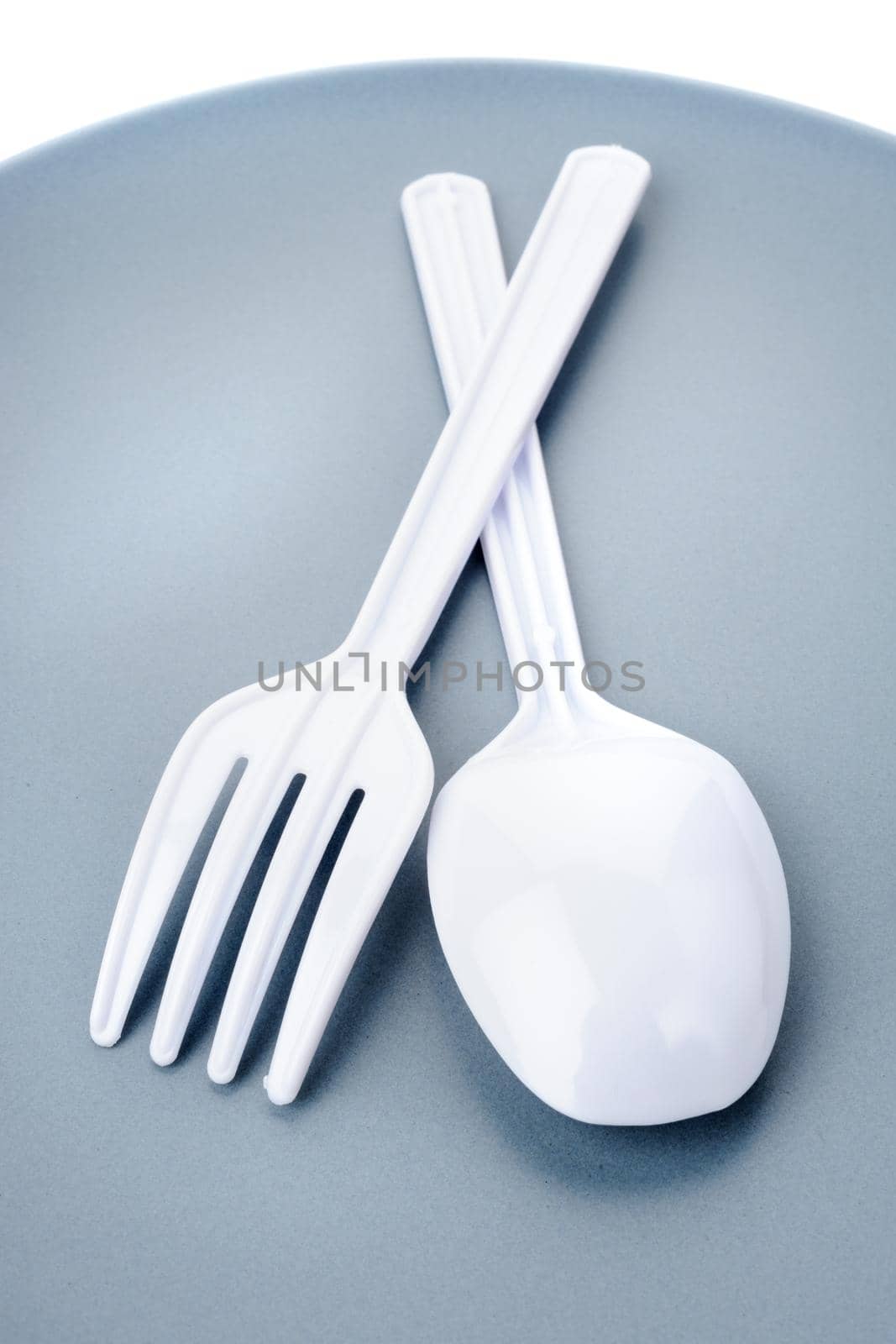 closeup plastic cutlery on plate