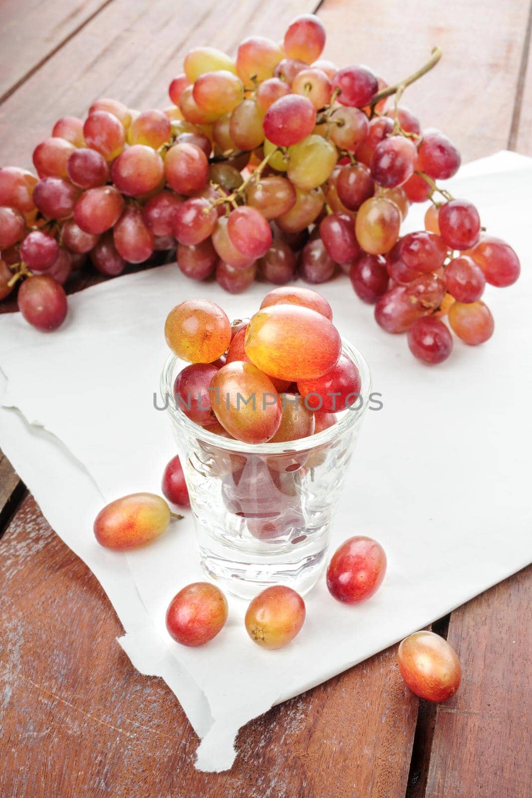 closeup fresh red grapes on wooden plank