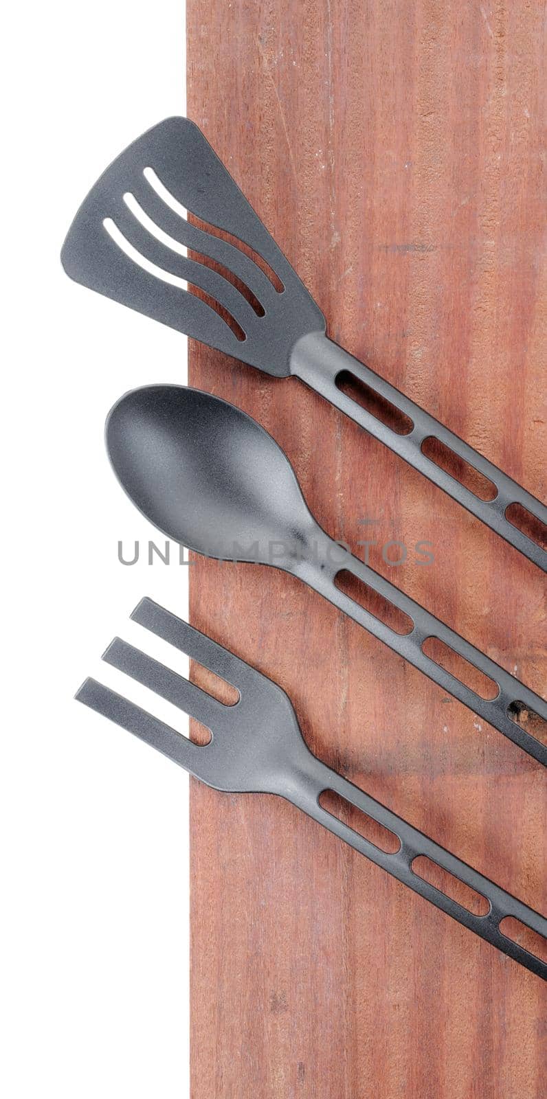 set of plastic spade of frying pan on wooden plank background