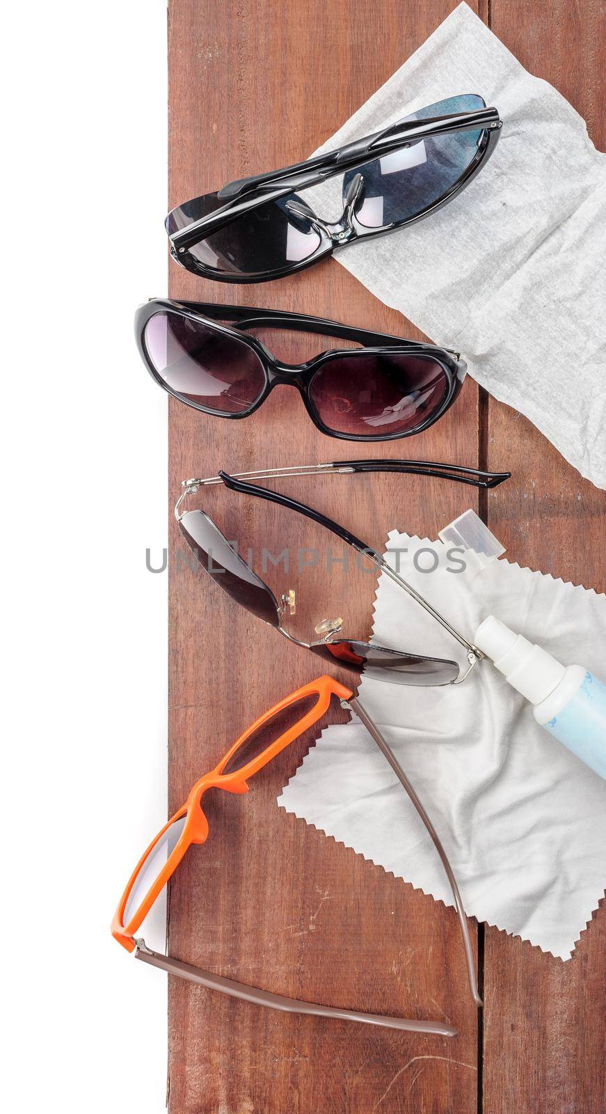 isolated four sunglasses on wooden plank