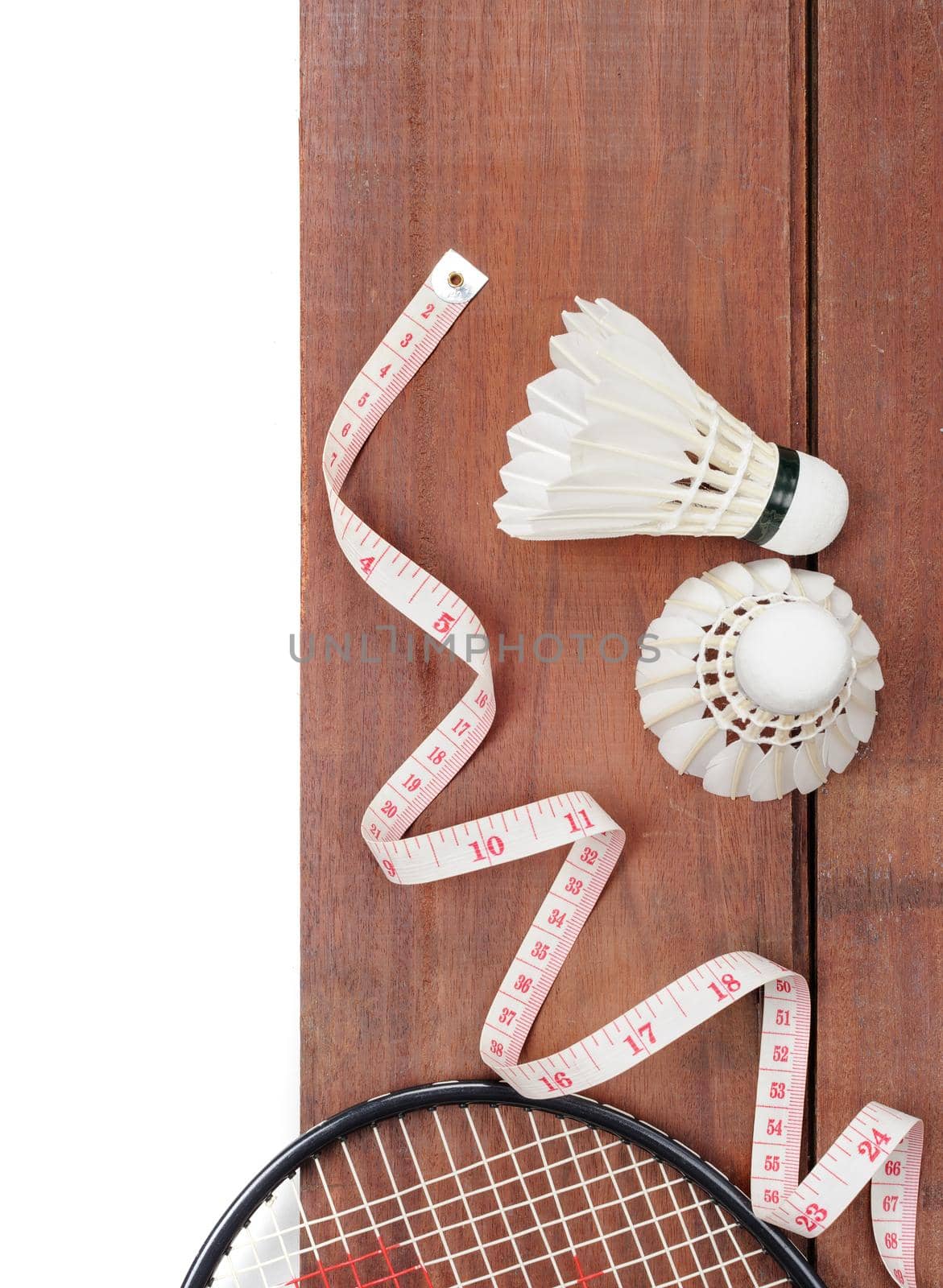 closeup shuttlecocks and tape measure isolated on wooden plank