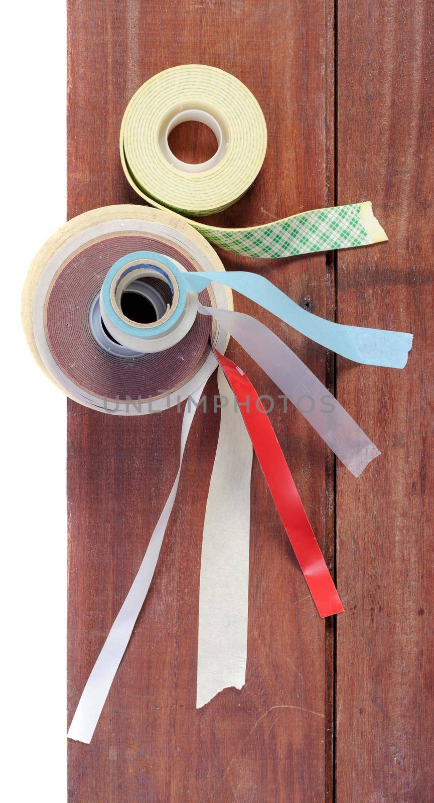 many type of adhesive tape on wooden plank, working background