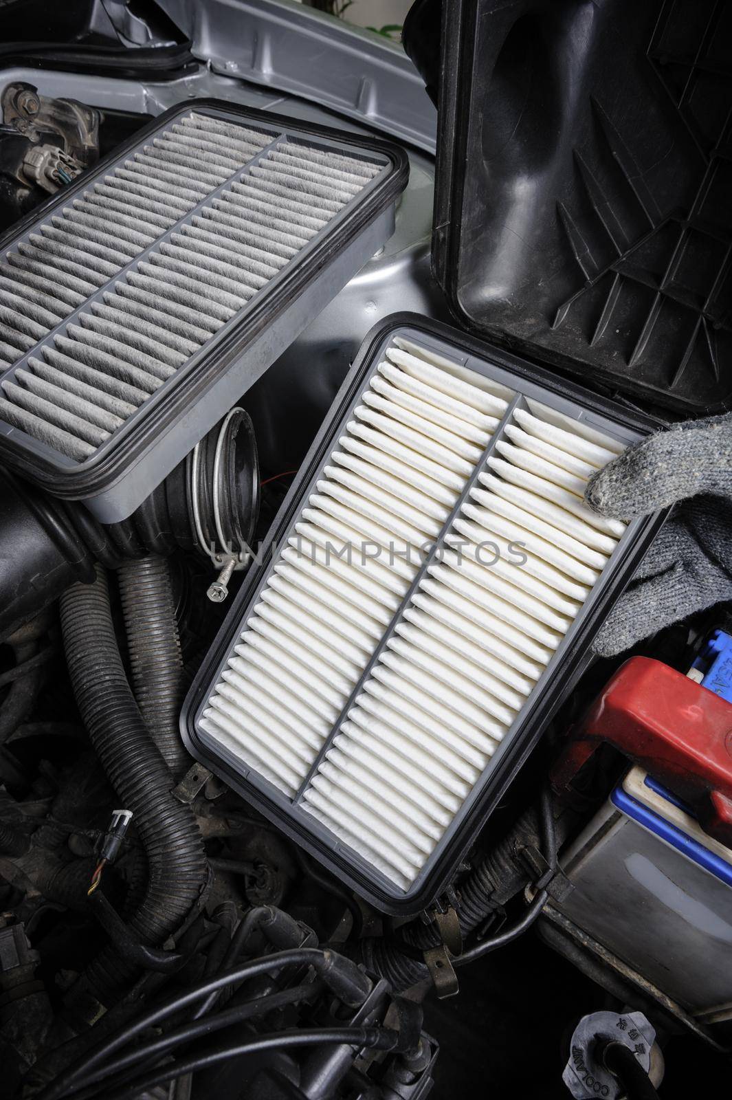 technician changing the air filter for car