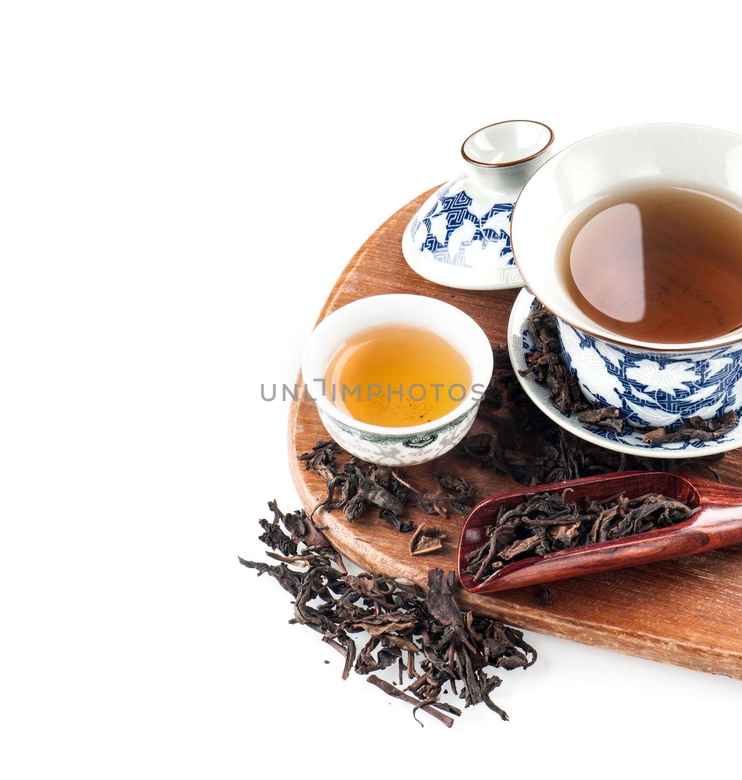 tea cup with tea leaves isolated on white background
