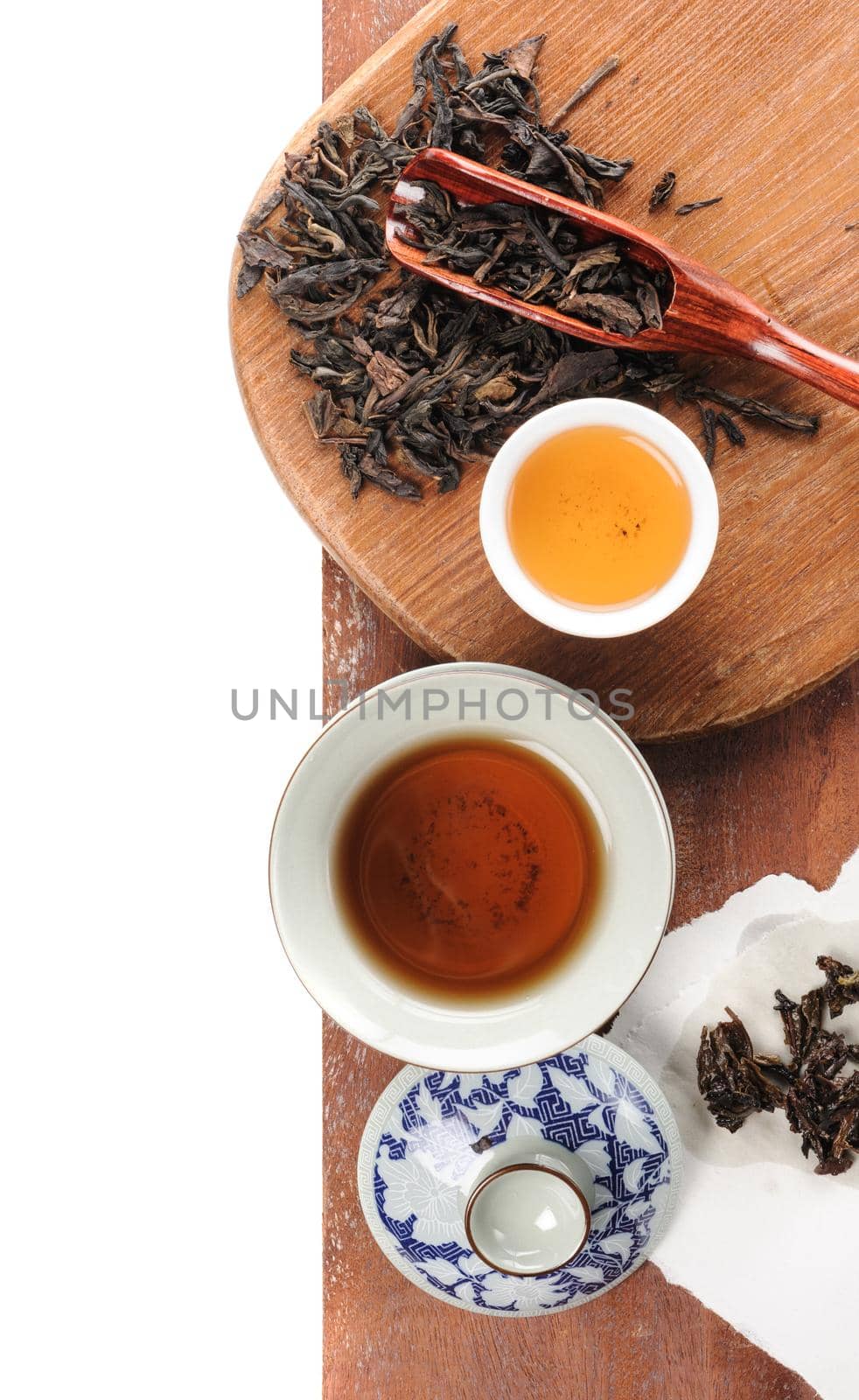 tea cup with tea leaves isolated on white background
