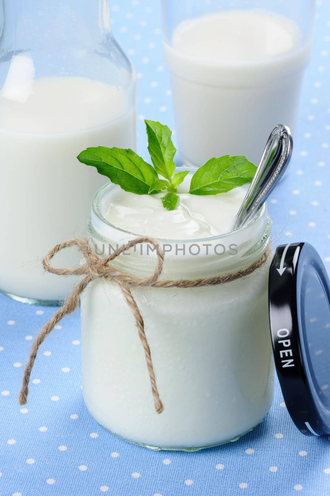 fresh natural yogurt in glass jar, delicious natural yogurt 