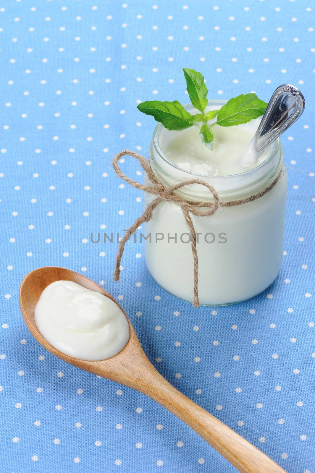 fresh natural yogurt in glass jar, delicious natural yogurt 