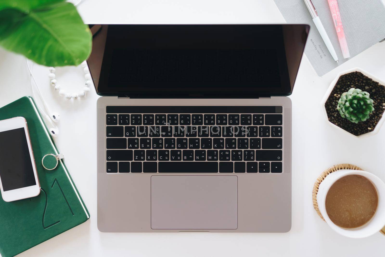 Top view of modern laptop or notebook with phone to work. Office desktop on table background.